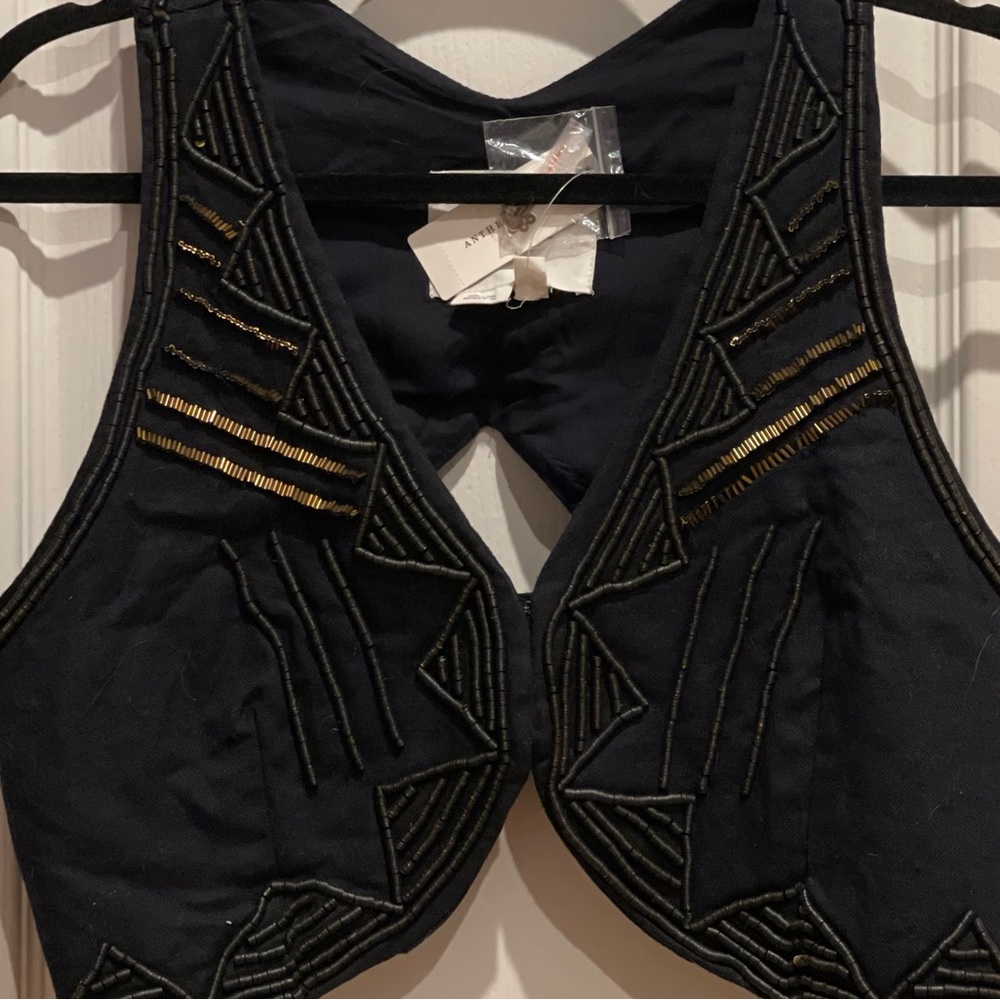 - Anthropology top/vest  three (3) snap/hooks in front.